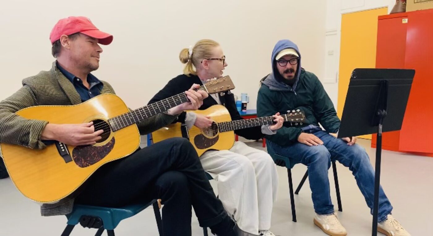CUSP facilitators and members making music together on guitars and harmonica